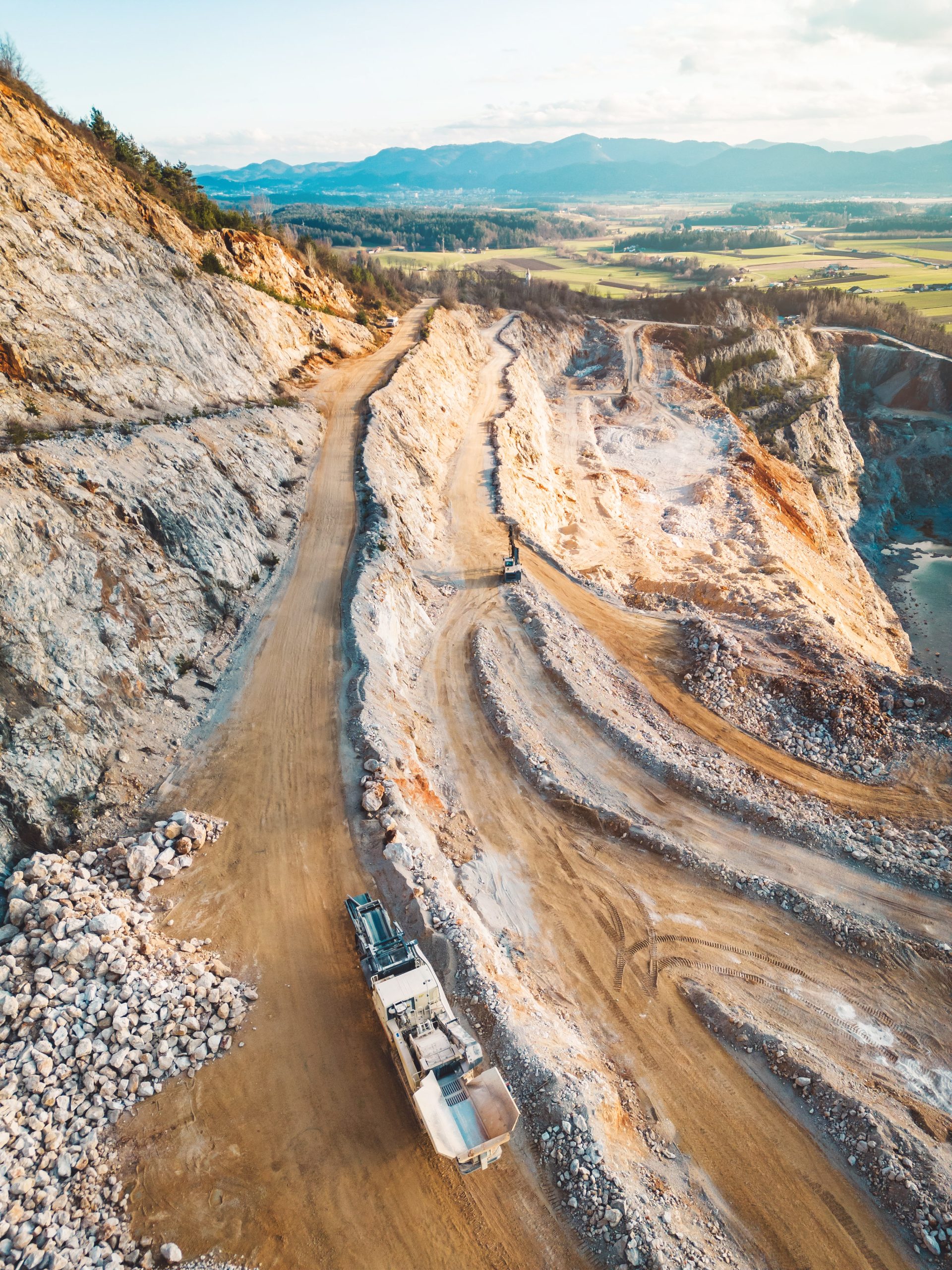 vertical photo of gravel roads on the side of the open pit quarry